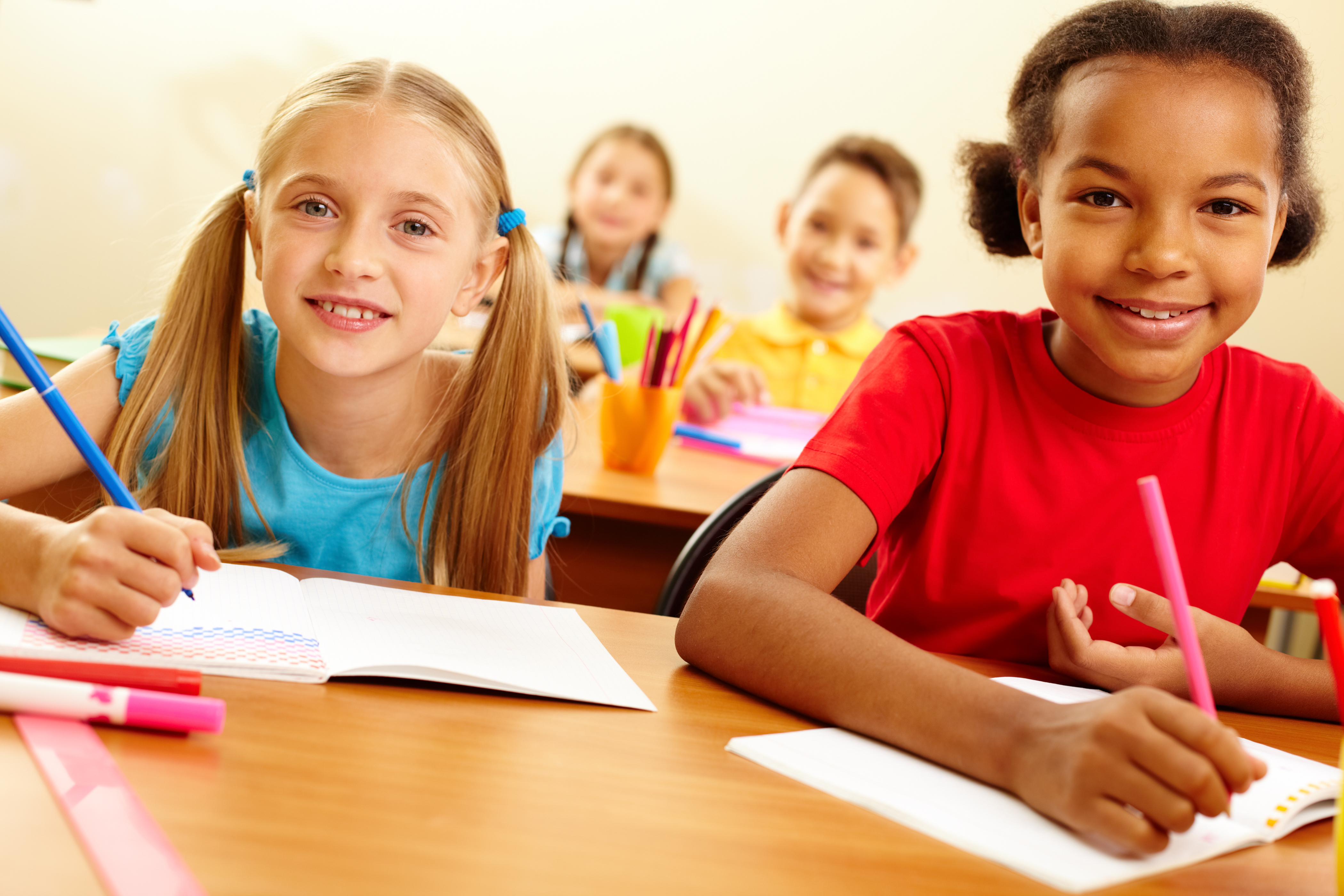 Portrait of lovely girls looking at camera at lesson